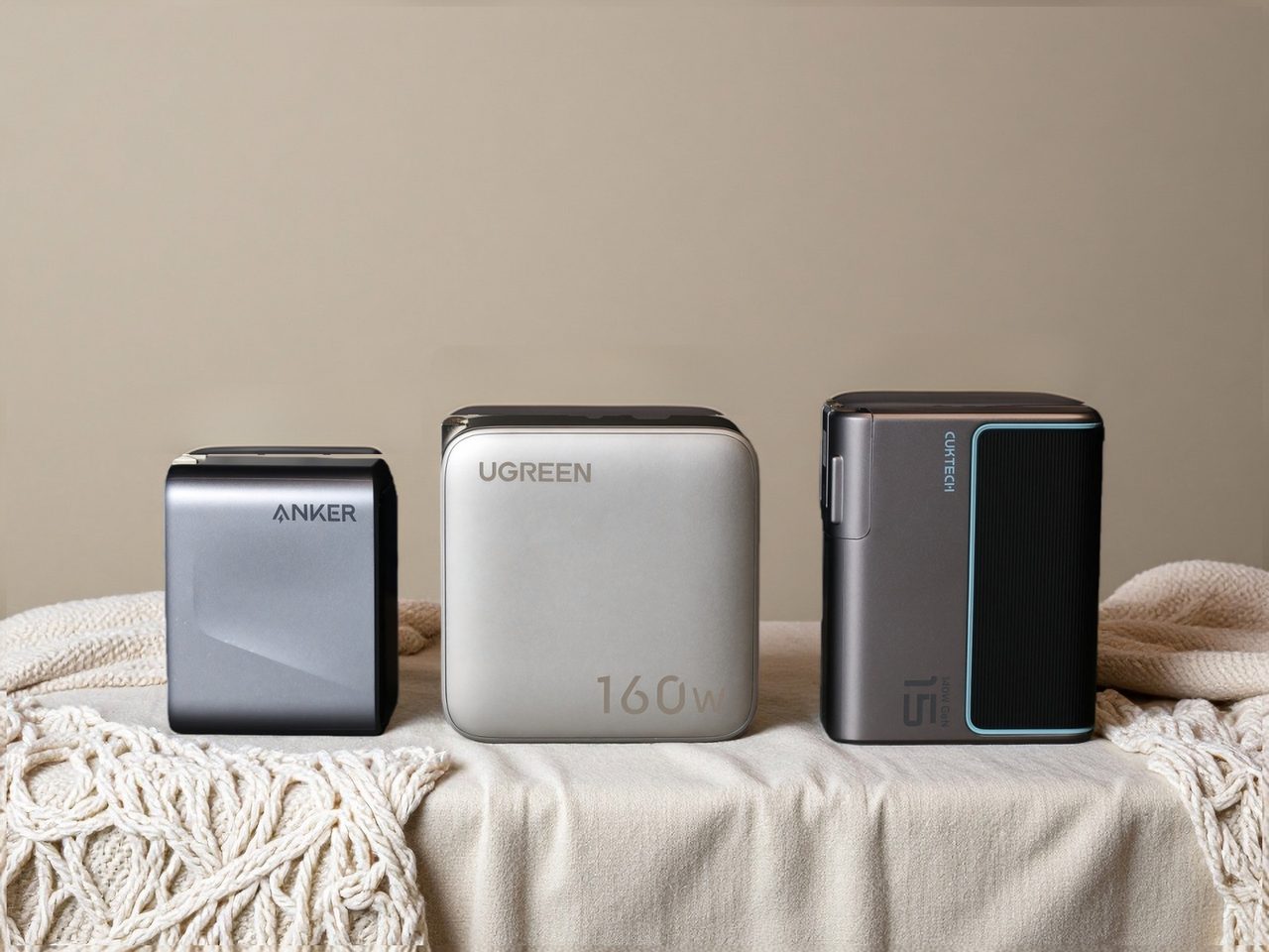Three multi-port GaN wall chargers of different wattages photographed side by side