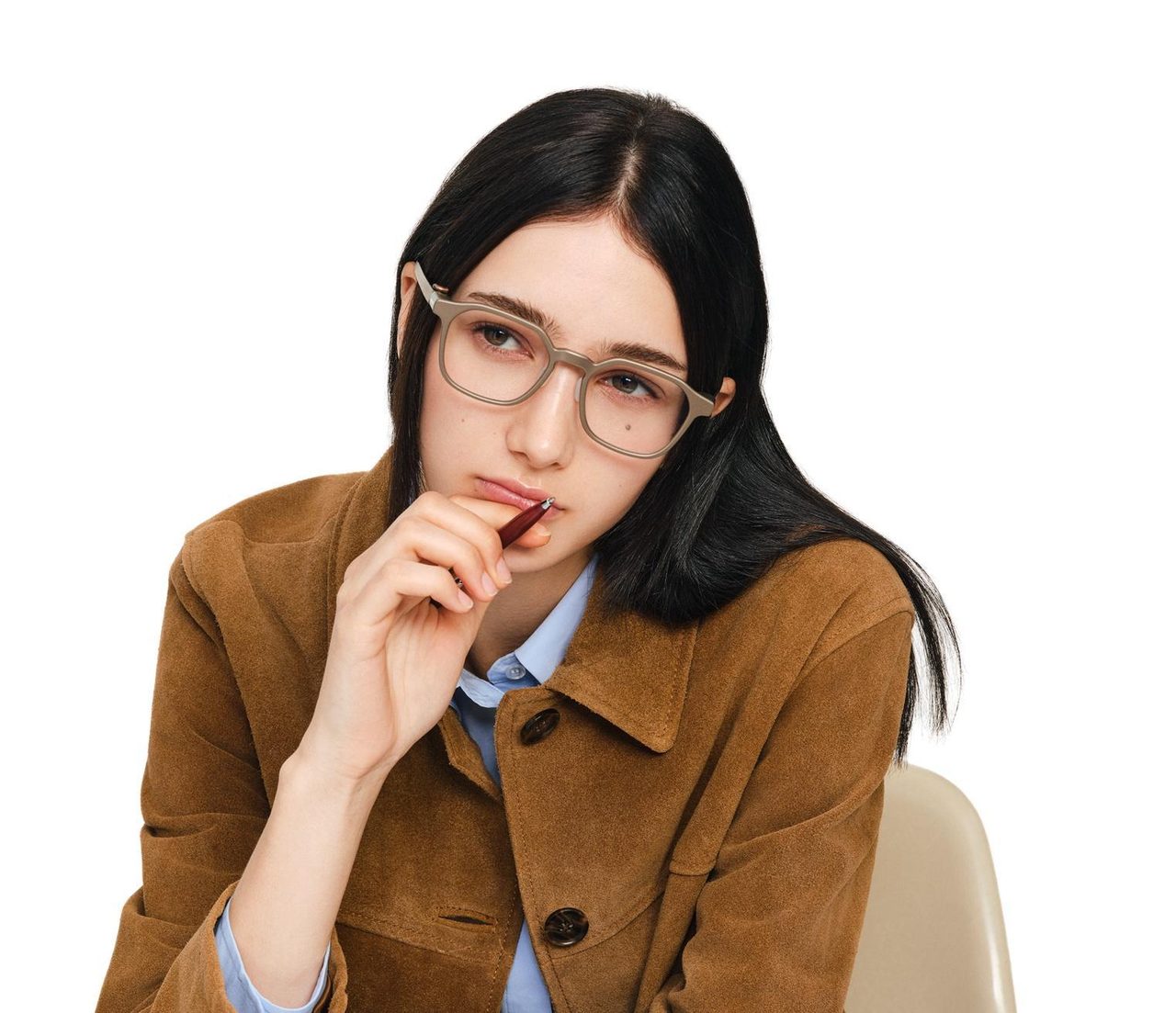 A person wearing glasses while reading a phone