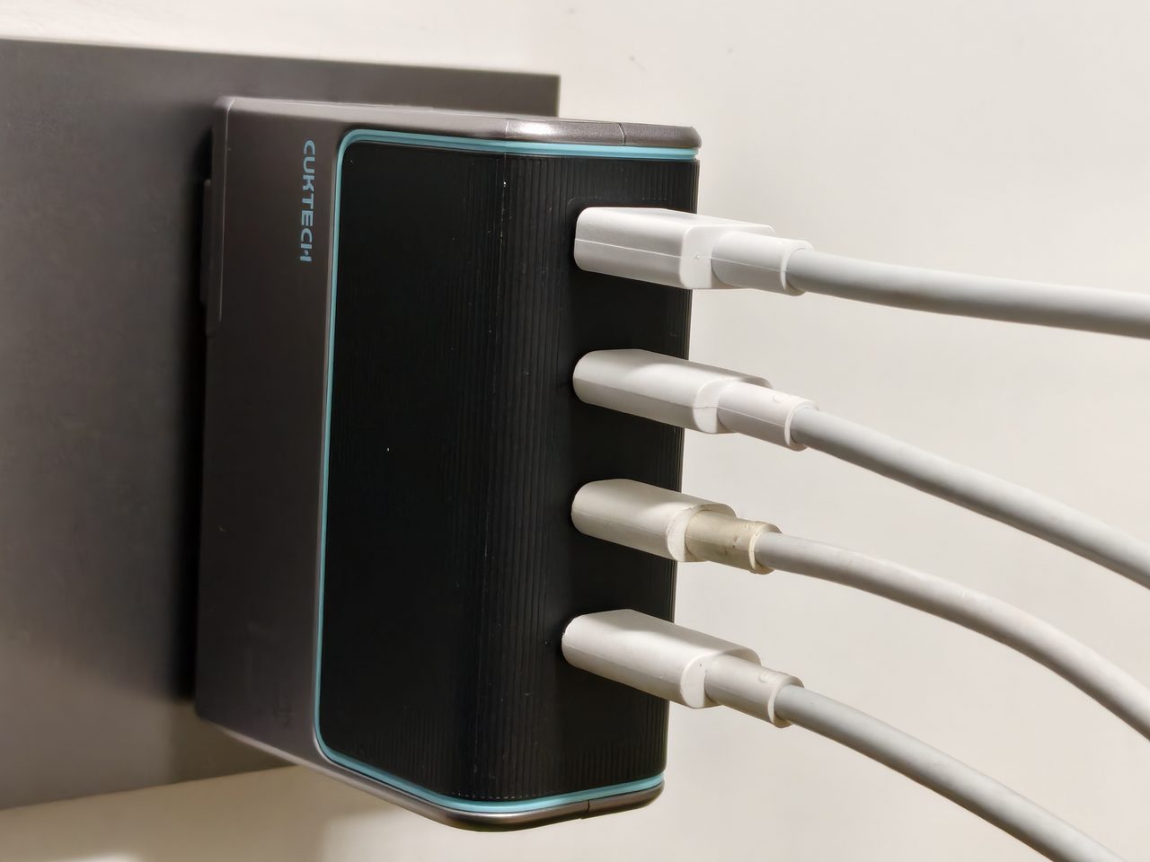 A multi-port charger with four cables plugged in at the same time