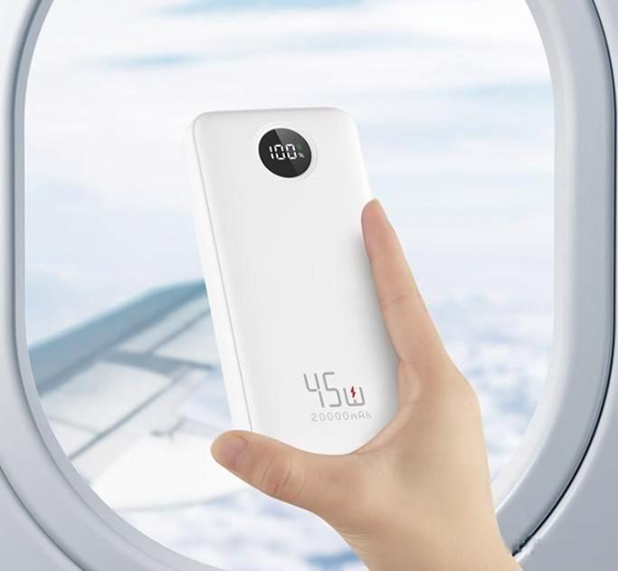 A magnetic power bank held in the palm while attached to a phone