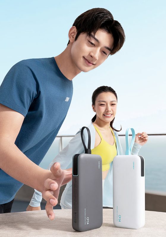 Two travellers holding power banks at an airport terminal