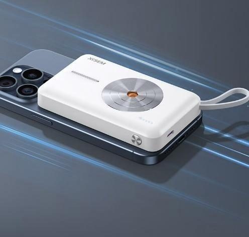 A magnetic power bank attached to the back of a smartphone