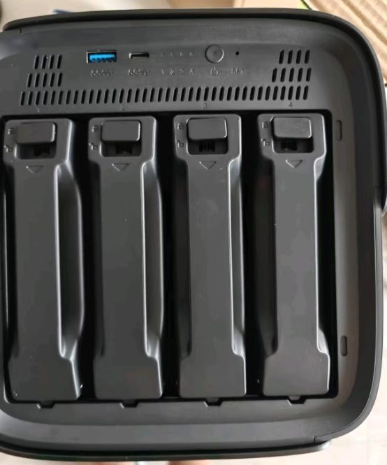 Drive bay trays removed from an enclosure showing the mounting positions